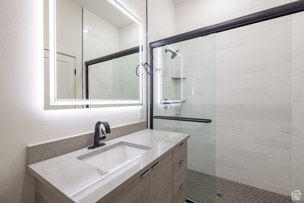 Bathroom with vanity and a tile shower
