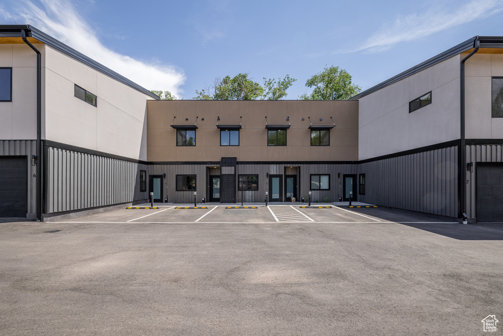 View of building exterior featuring uncovered parking