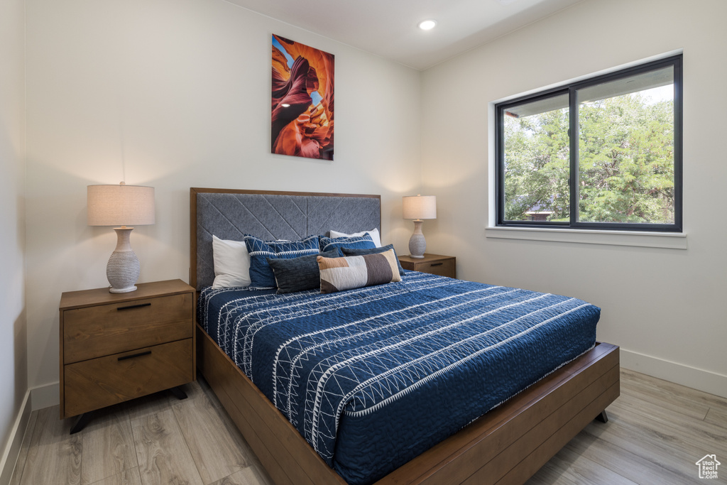 Bedroom featuring light wood-type flooring, baseboards, and recessed lighting