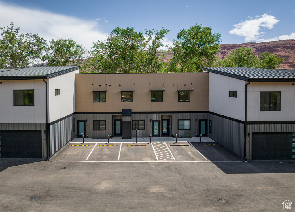 View of property with uncovered parking