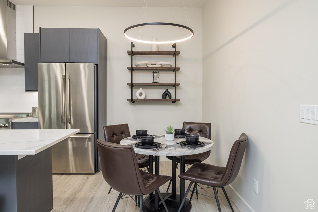 Dining area with light wood-style flooring