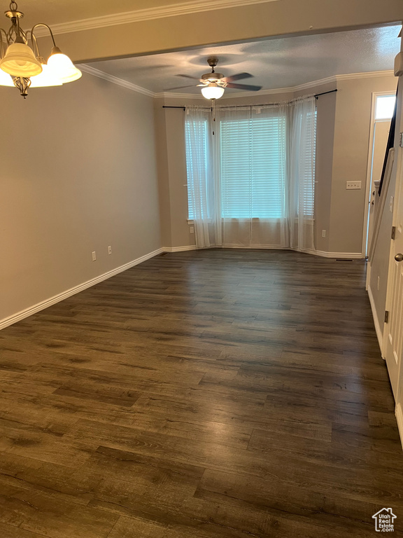 Unfurnished room with dark wood finished floors, a ceiling fan, and crown molding