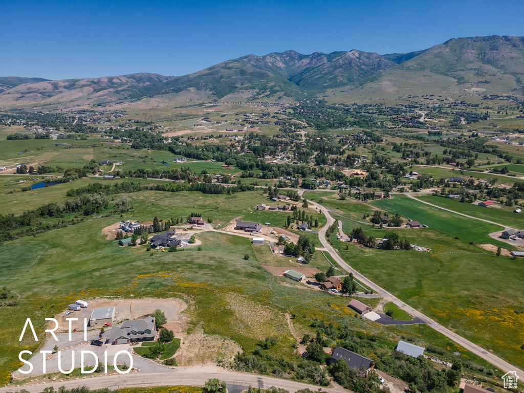 Aerial view of property and surrounding area with mountains