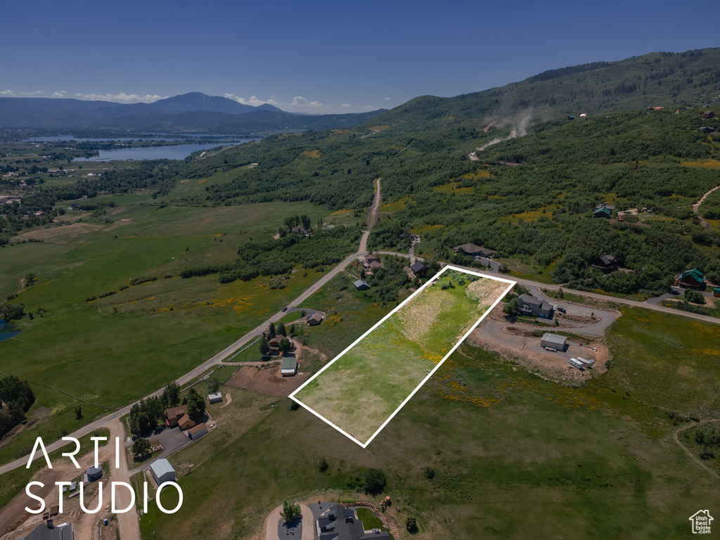 Aerial view of property's location featuring a water and mountain view and property boundaries highlighted