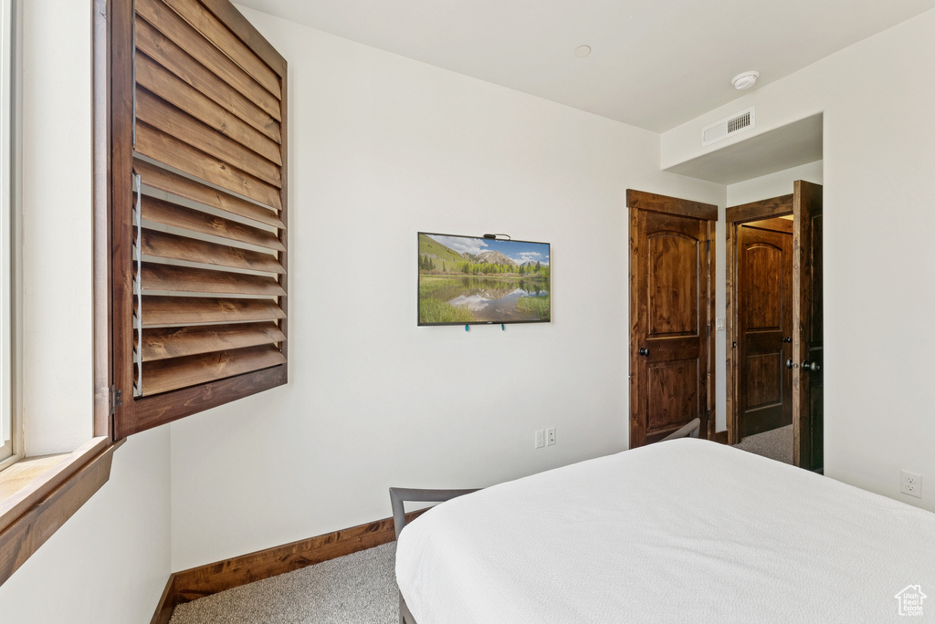 Bedroom with carpet and baseboards
