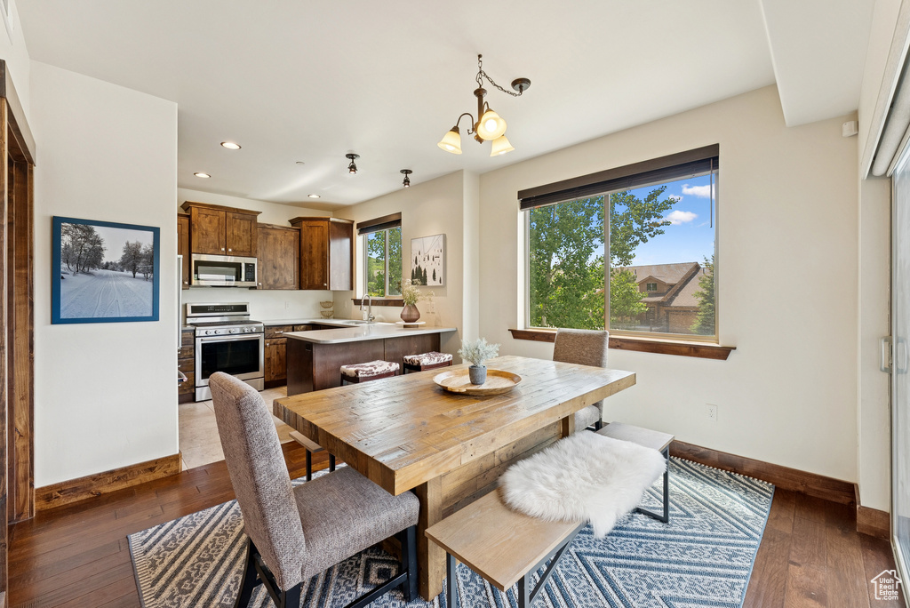 Dining space featuring dark wood-style floors and recessed lighting