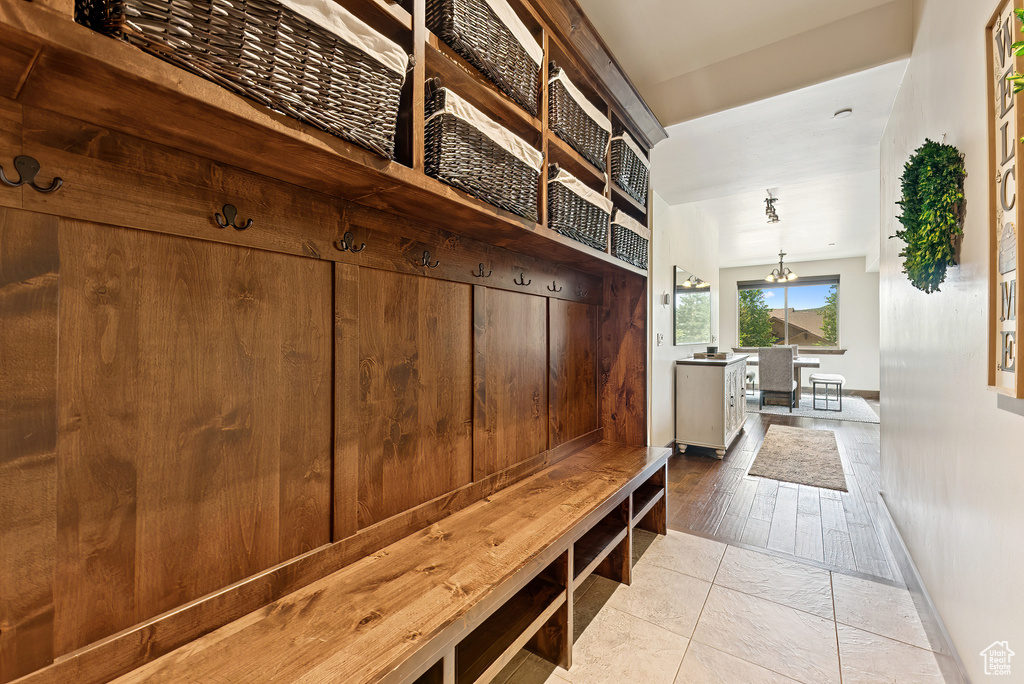 Mudroom with a chandelier and baseboards