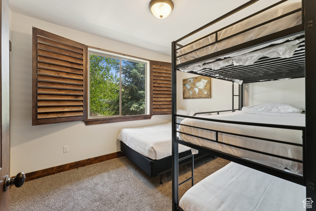 Carpeted bedroom featuring baseboards