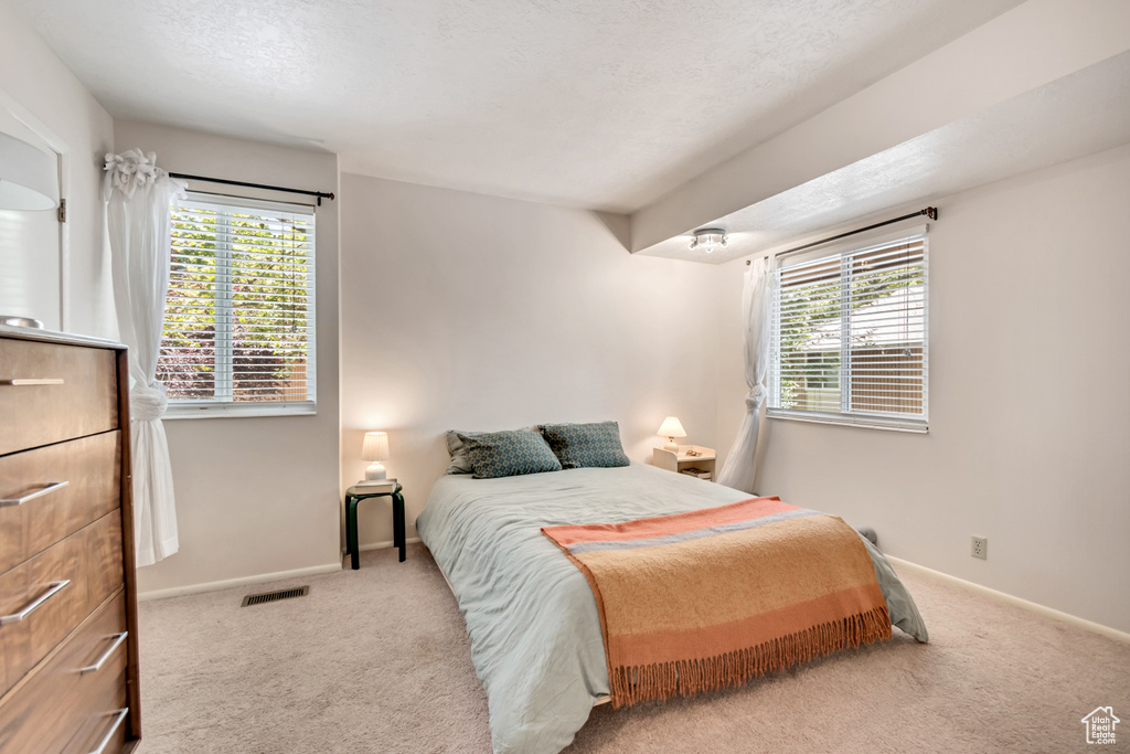 Bedroom featuring carpet floors and baseboards