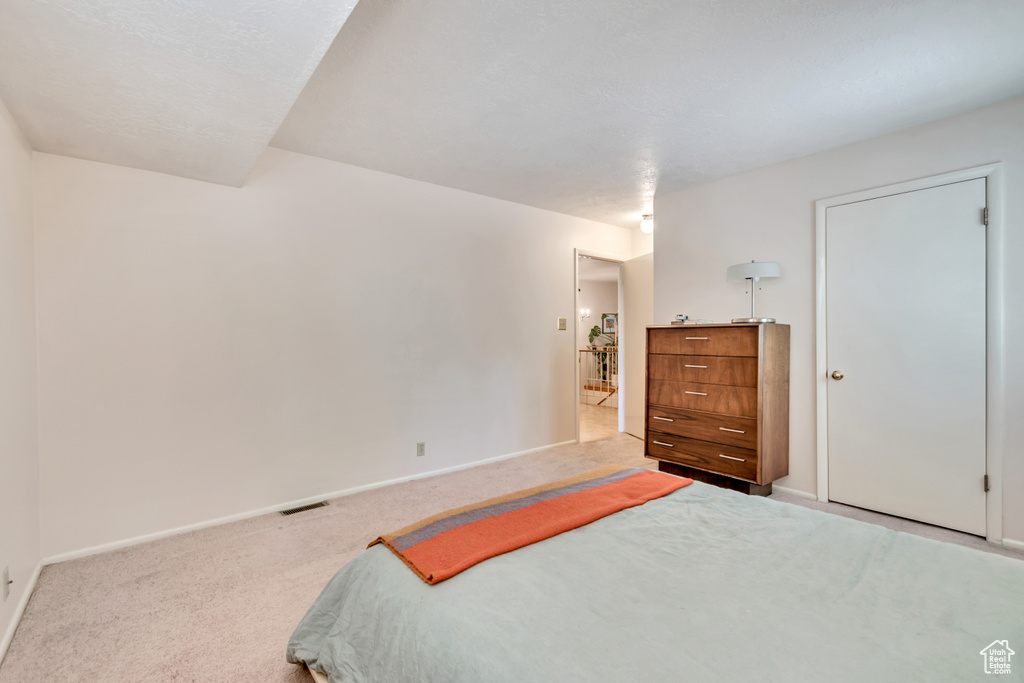 Bedroom featuring carpet floors and baseboards