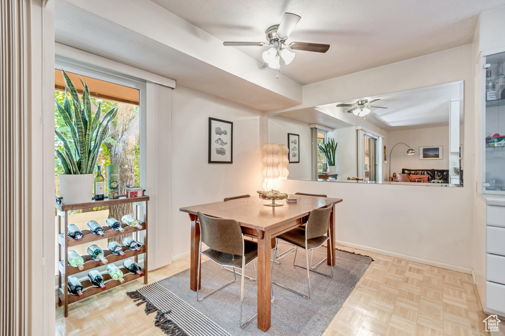 Dining space with a ceiling fan and baseboards