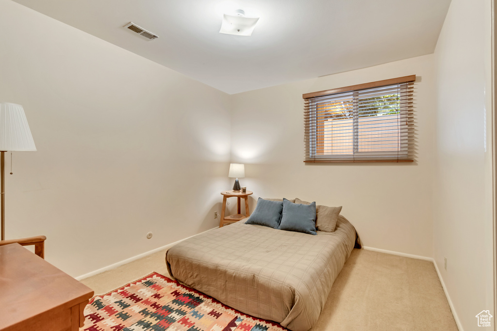 Bedroom featuring carpet floors and baseboards