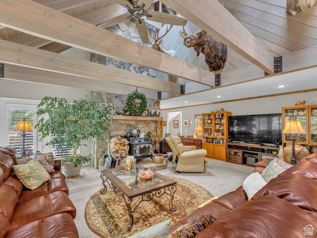 Living area with carpet, a wood stove, a ceiling fan, and recessed lighting