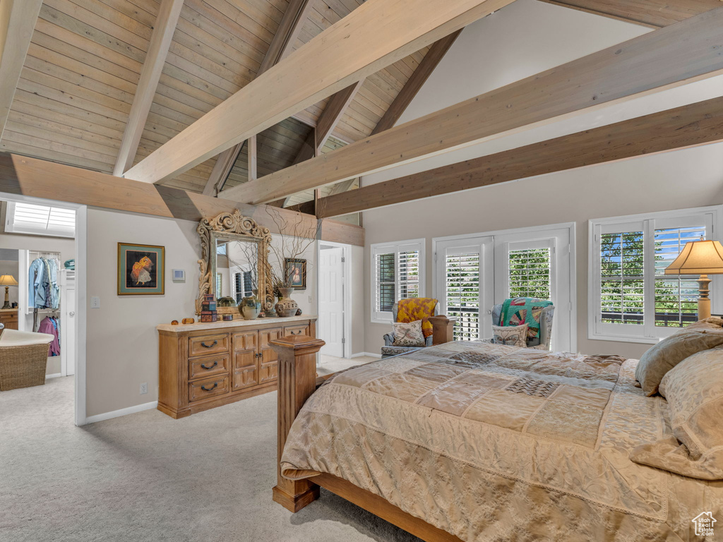 Carpeted bedroom featuring a wood ceiling with exposed beams, high vaulted ceiling, and access to exterior