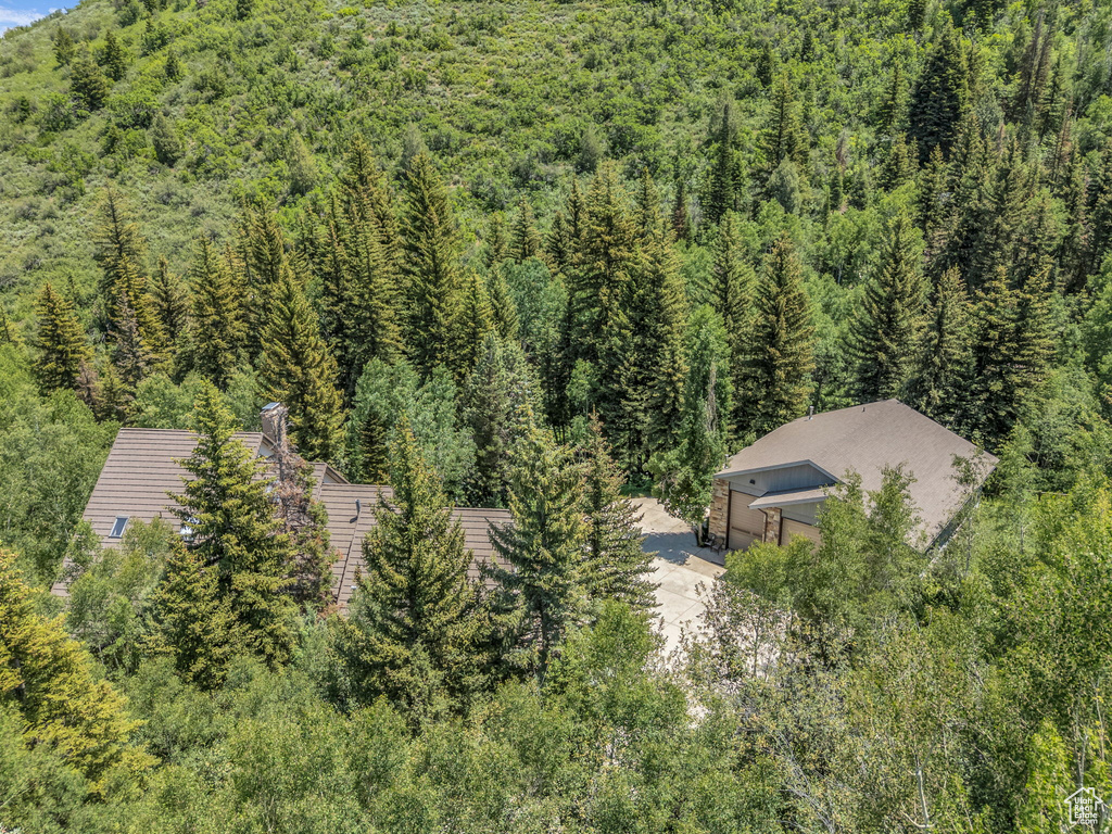 View from above of property with a forest