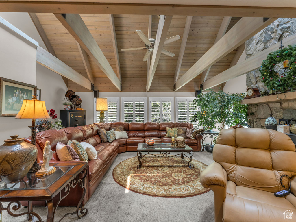 Carpeted living area featuring wooden ceiling and ceiling fan