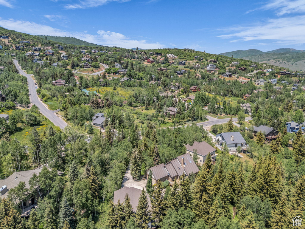 Aerial overview of property's location featuring nearby suburban area and a mountain backdrop