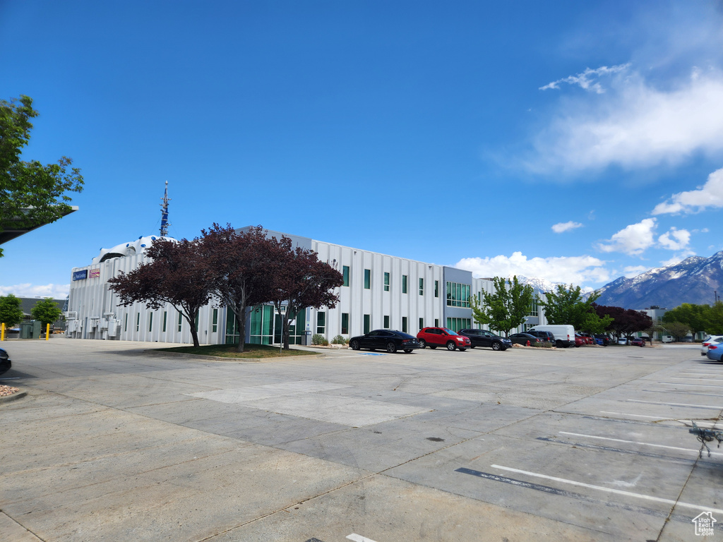 View of property featuring uncovered parking and a mountain view