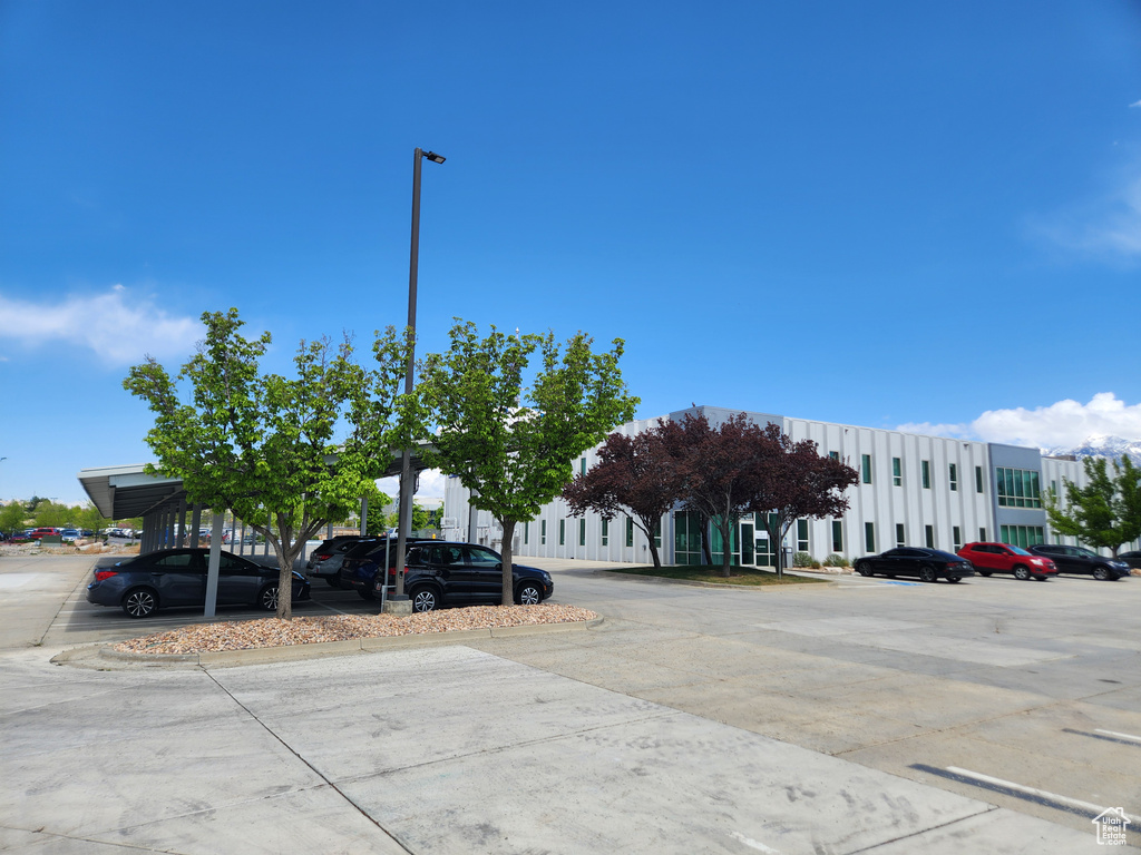 View of building exterior featuring uncovered parking