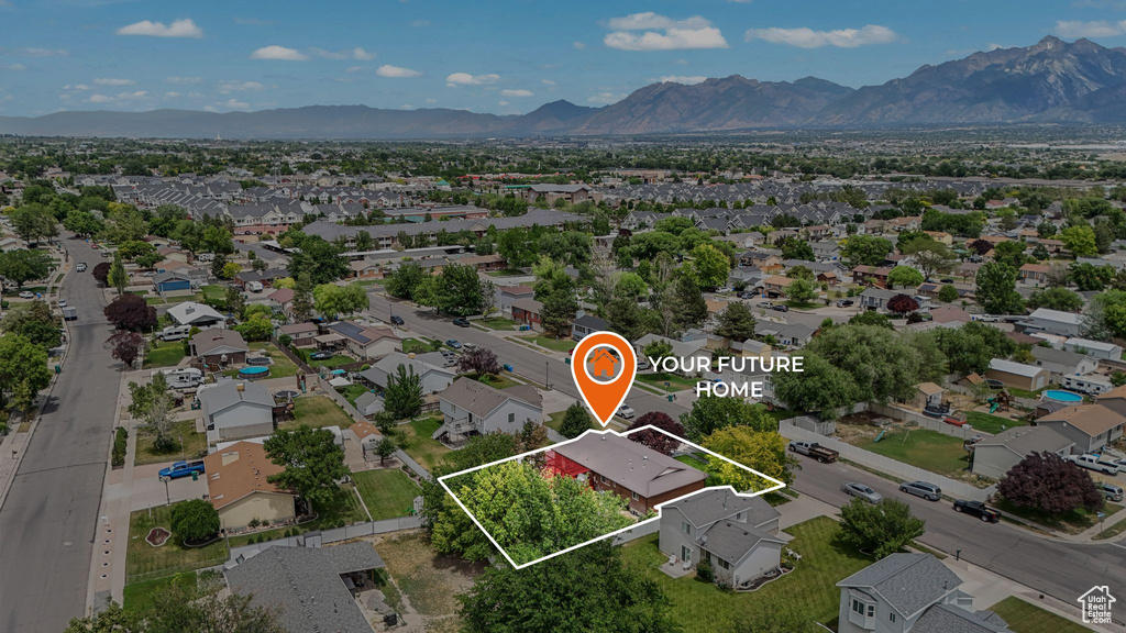 Aerial perspective of suburban area with mountains and property parcel outlined