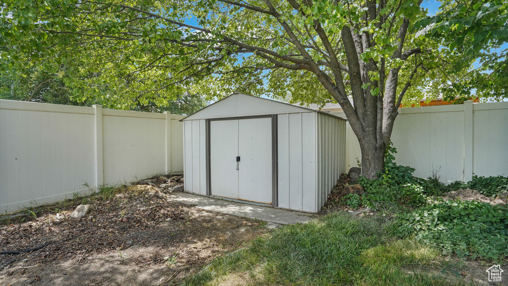 View of shed with a fenced backyard