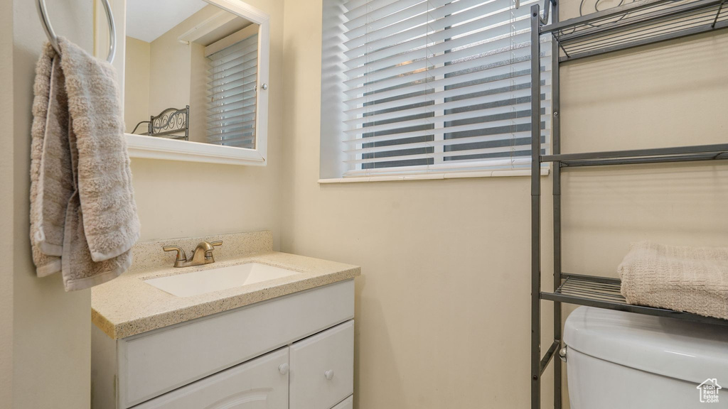 Half bathroom featuring toilet and vanity