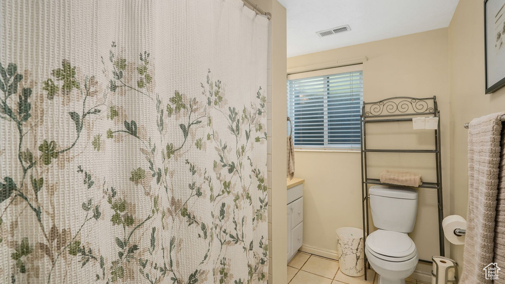Full bathroom featuring tile patterned flooring, vanity, and a shower with shower curtain