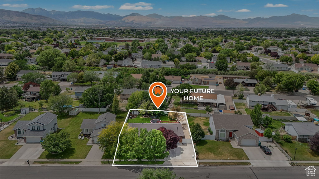 Aerial perspective of suburban area featuring property parcel outlined and mountains