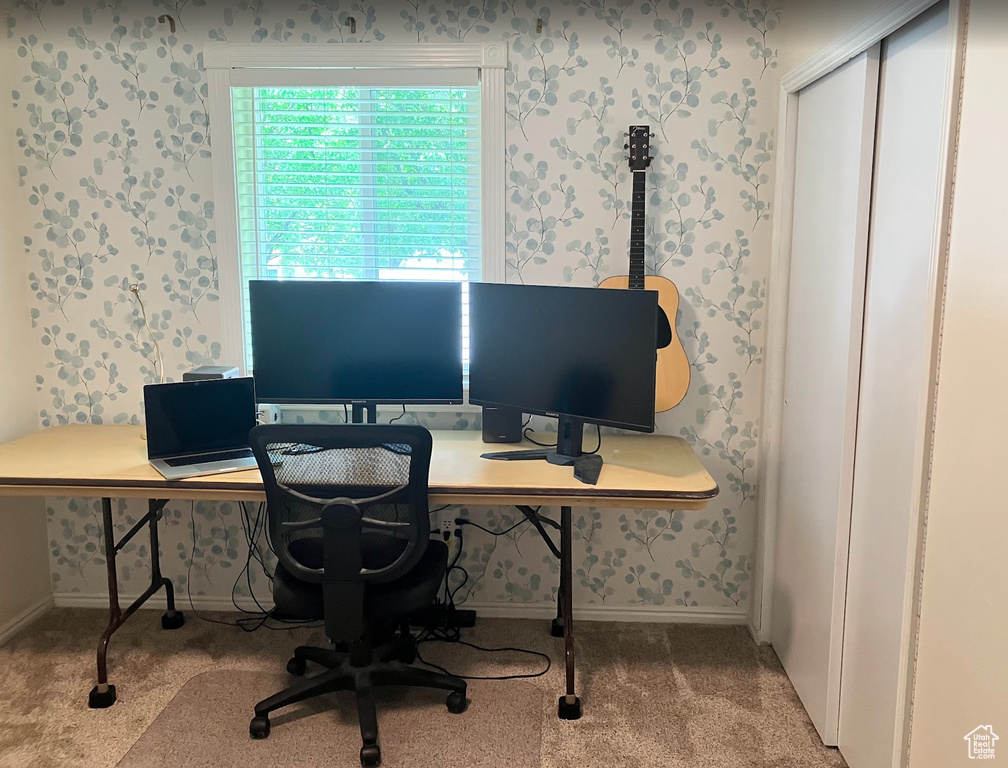 Carpeted office space featuring wallpapered walls
