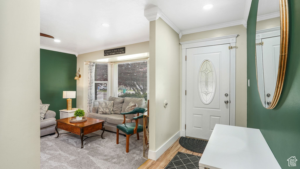 Foyer with crown molding, light wood-style flooring, and recessed lighting