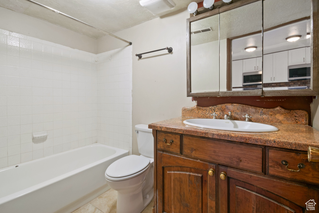 Full bathroom featuring vanity, bathtub / shower combination, and tile patterned floors