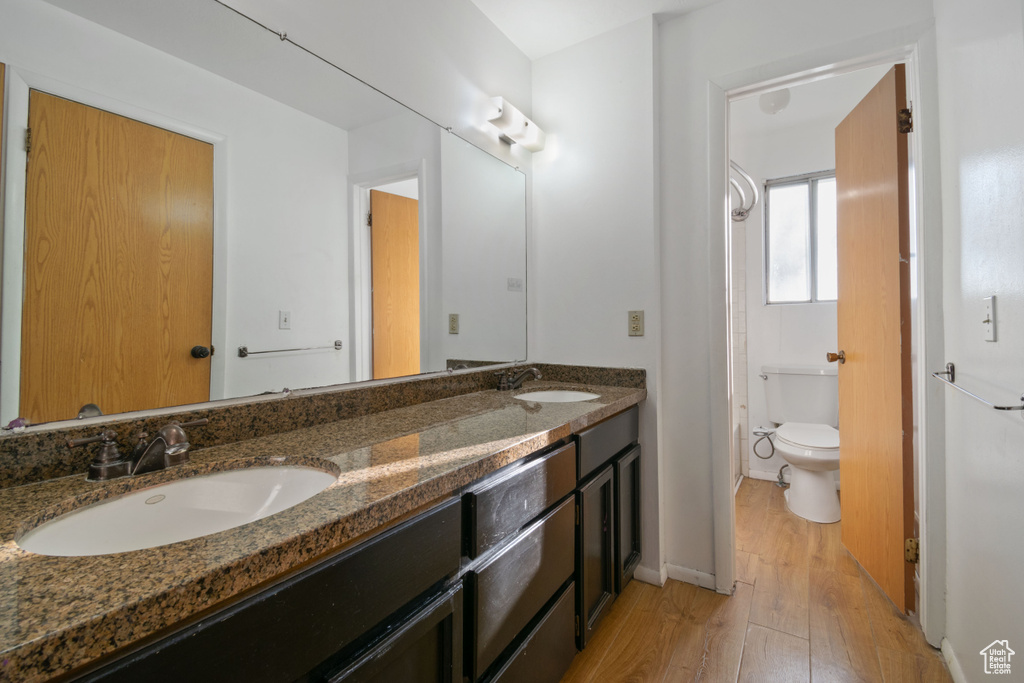 Bathroom featuring wood finished floors and double vanity