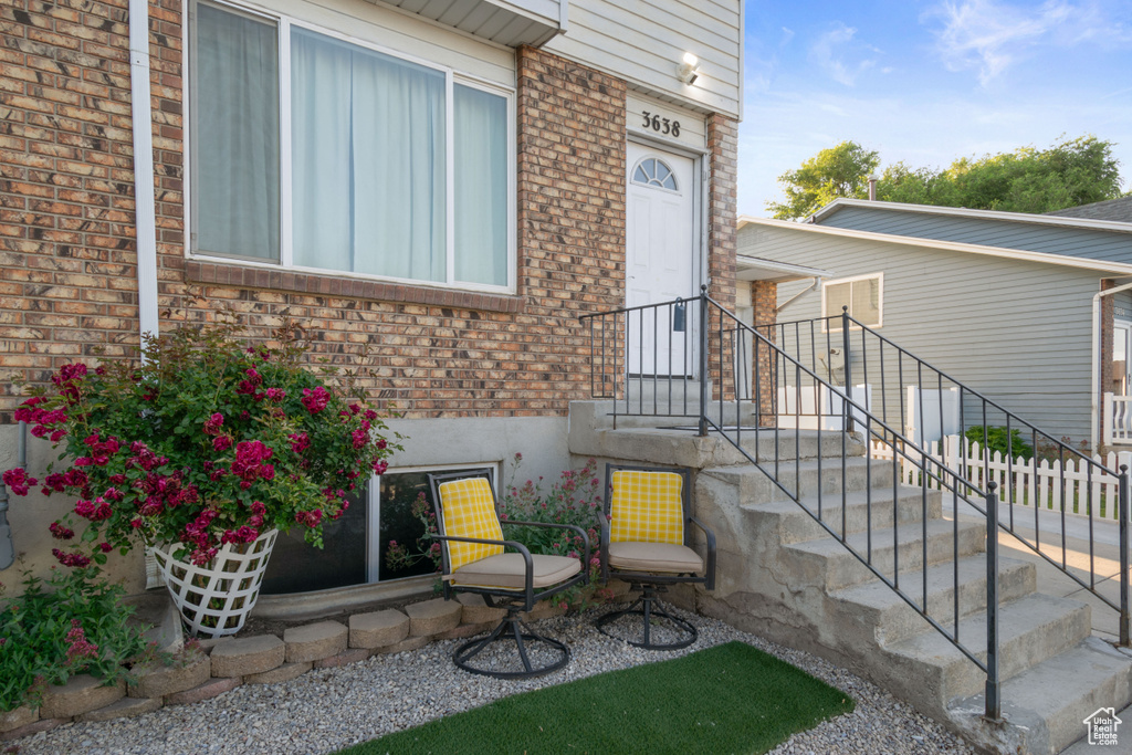 View of exterior entry with brick siding
