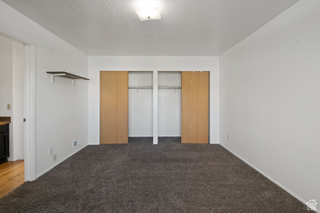 Unfurnished bedroom featuring two closets and carpet floors