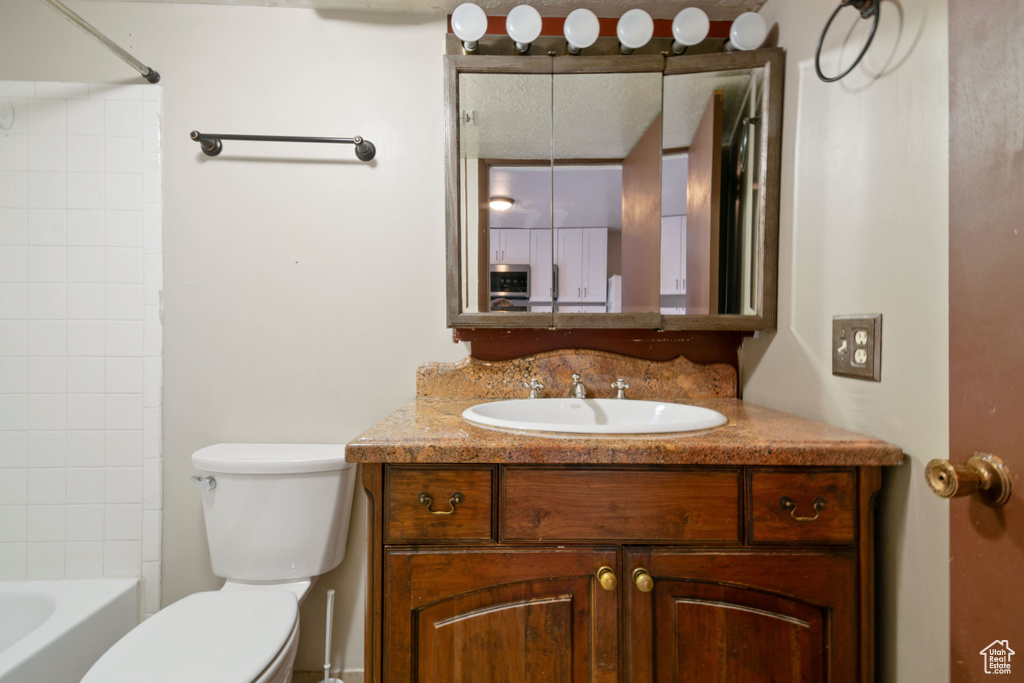 Bathroom featuring vanity and shower / bath combination