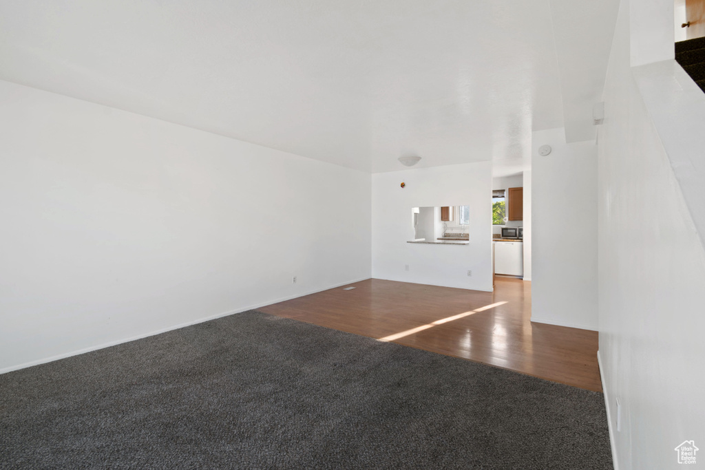 Unfurnished living room with carpet floors