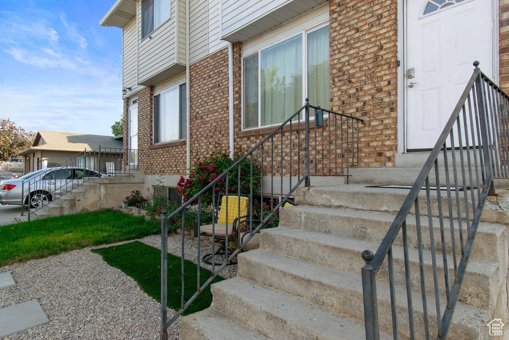 View of exterior entry featuring brick siding