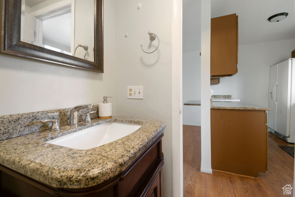Bathroom featuring wood finished floors and vanity