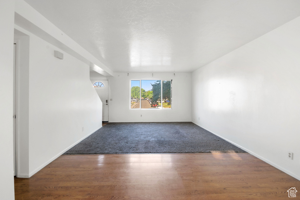 Spare room with wood finished floors and baseboards
