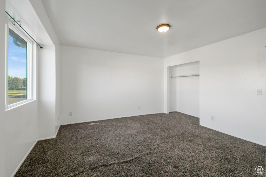 Unfurnished bedroom with carpet and a closet