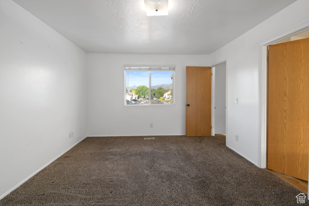 Unfurnished room featuring carpet flooring and baseboards