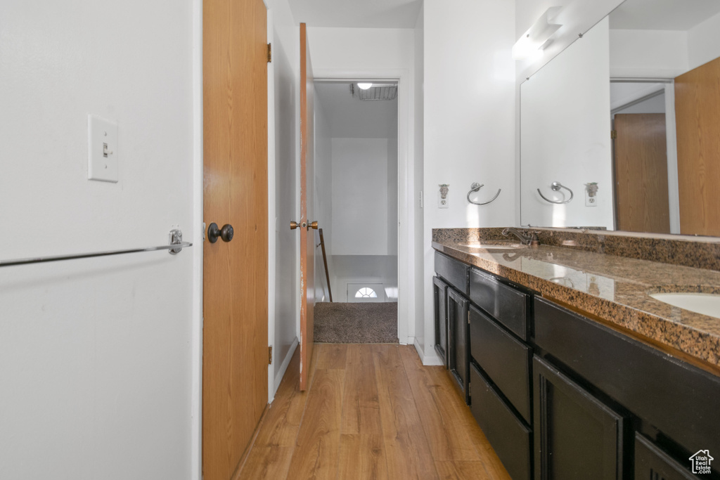 Bathroom featuring wood finished floors and double vanity