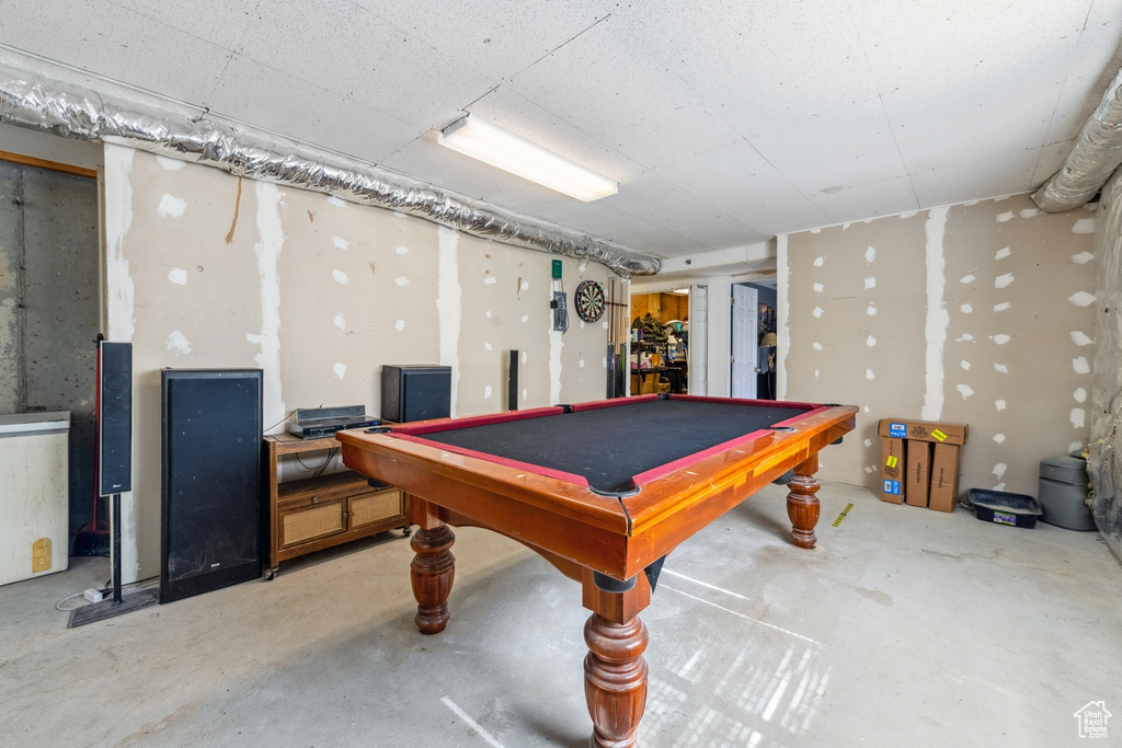 Game room featuring unfinished concrete flooring and billiards table