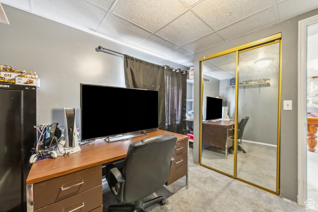 Carpeted home office with a paneled ceiling