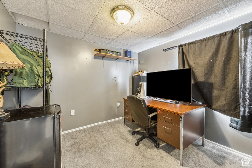 Office featuring light carpet and a paneled ceiling
