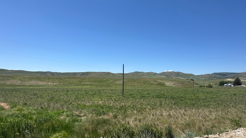 View of mountain backdrop featuring rural landscape