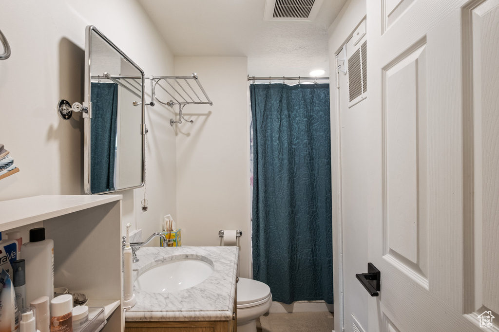 Bathroom featuring vanity and curtained shower