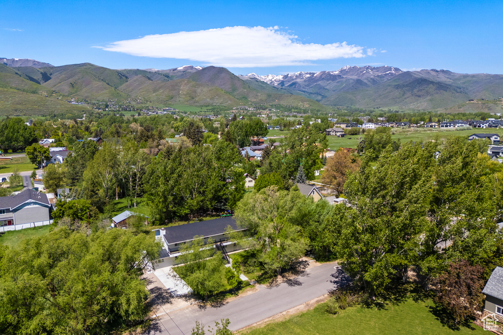 Aerial view of property and surrounding area with nearby suburban area