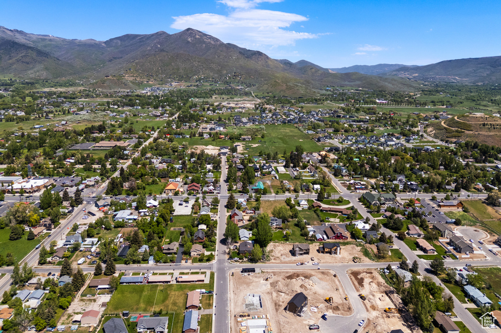 View of property location featuring mountains and nearby suburban area