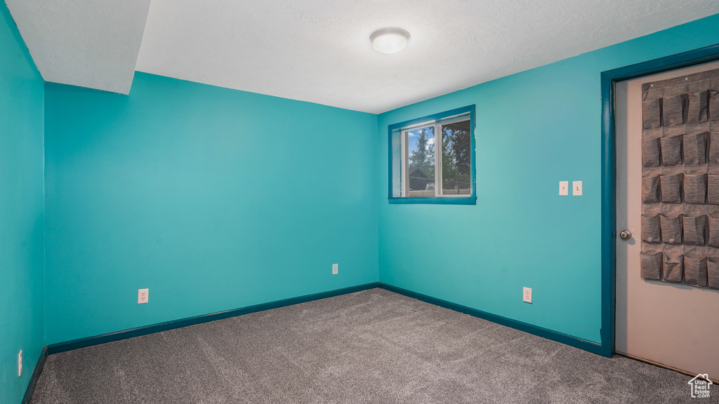 Carpeted spare room with baseboards